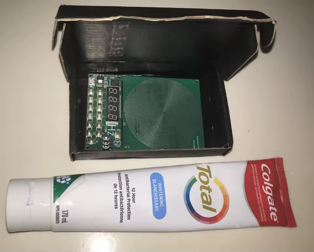 Generator in its box next to a toothpaste tube for scale